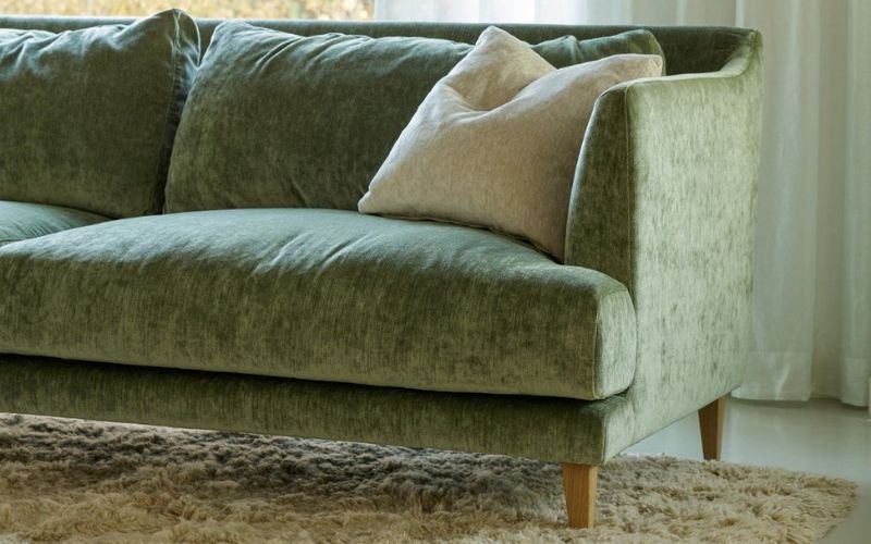 SITS Vera Sofa featuring high back cushions and a slender base, photographed in green fabric